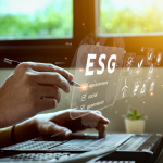 Business professional working on a laptop with a digital ESG interface highlighting environment, social, and governance factors.
